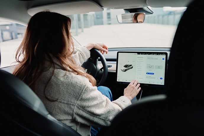 women driving electric car